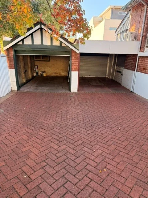 Rear parking area and garage approach on brick paving after cleaning