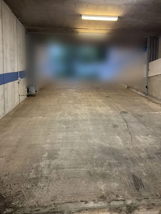 Concrete car park entry ramp cleared of leaf litter