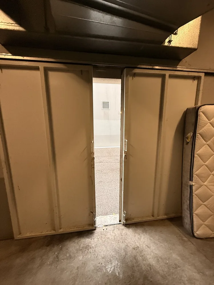 Double sliding bin room doors seen from inside, with only an internal floor bolt