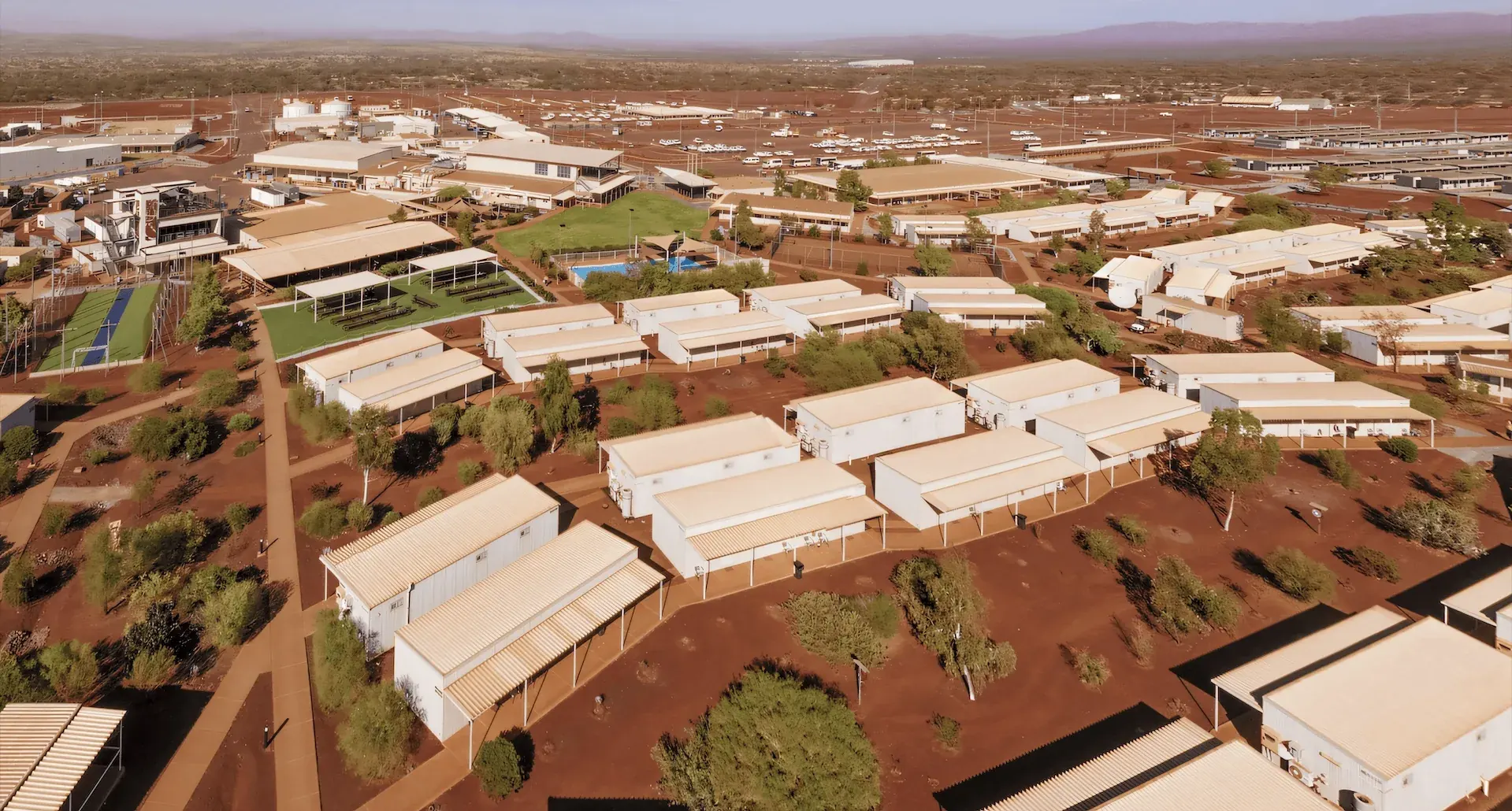 aus-mining-village Aerial view of a remote mining camp site in Australia, showcasing integrated property services in remote accommodation and facilities.