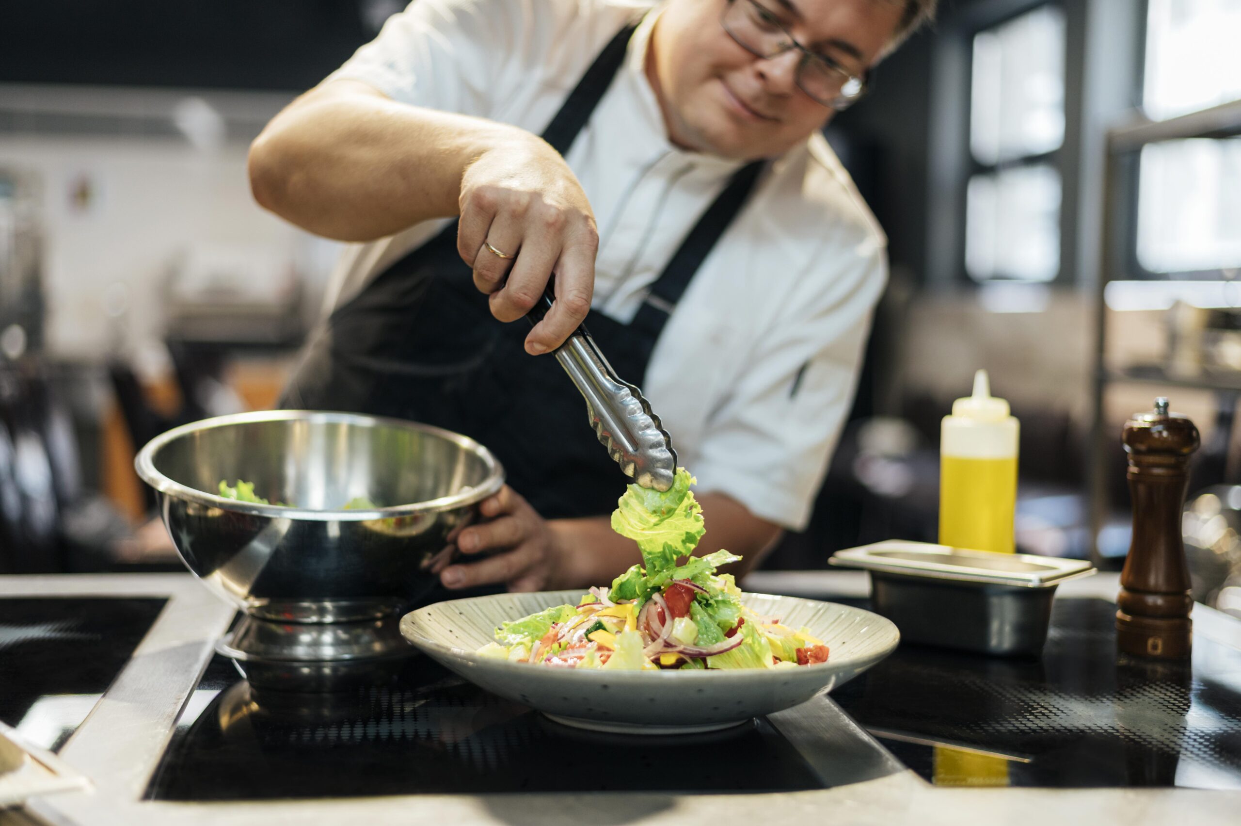 Chef crafting fresh salad with seasonal produce