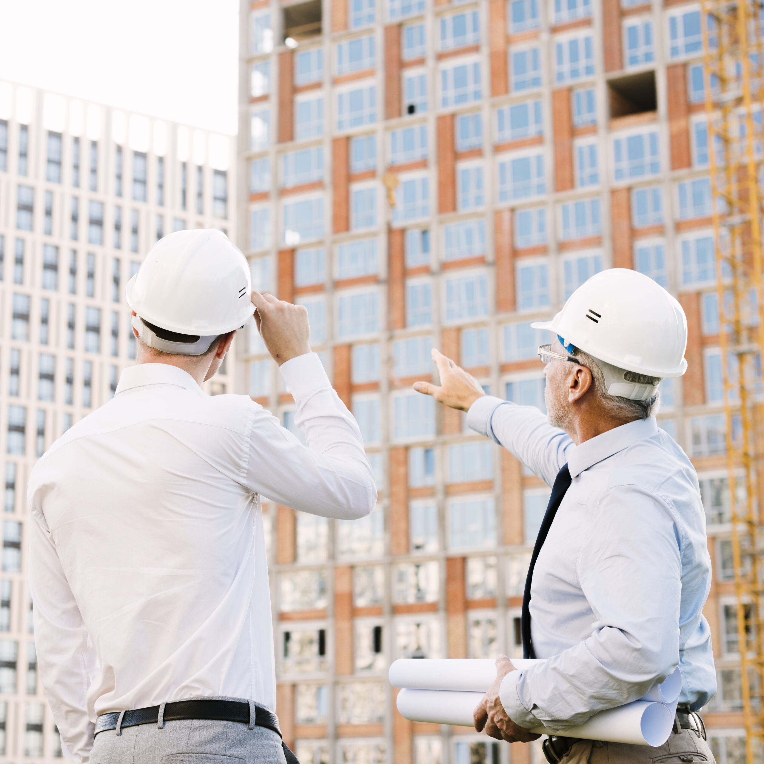 Inspector pointing out a building scaffolding issue during a condition assessment