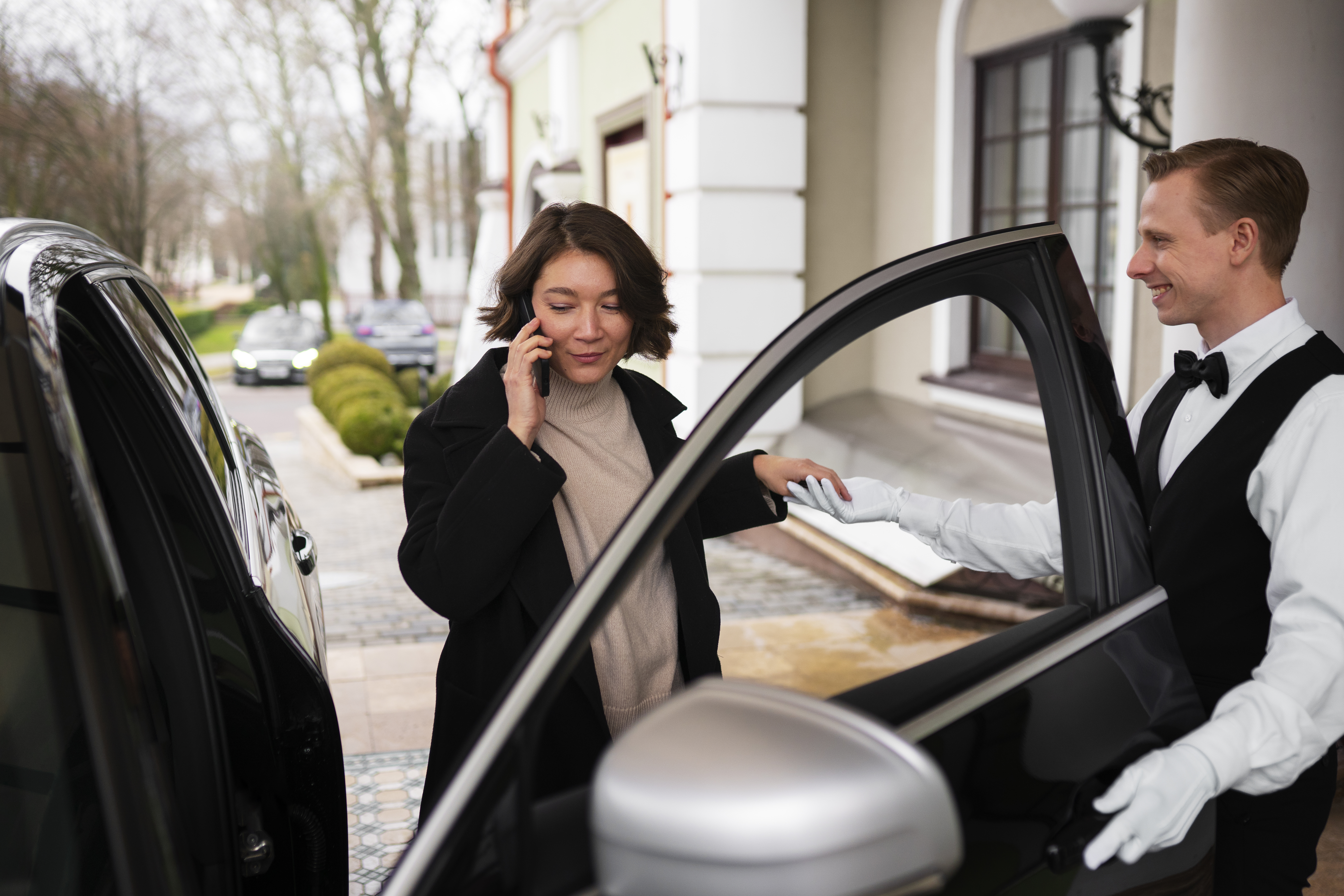 Valet attendant coordinating vehicle parking at a Perth building entrance
