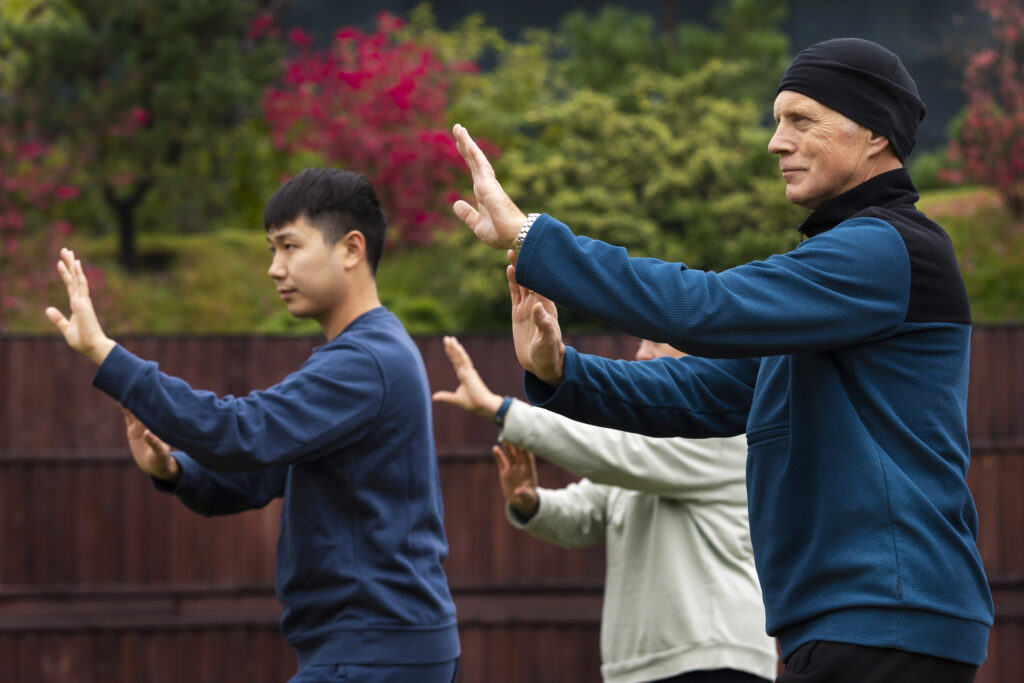 Mining workers participating in Tai Chi wellness session at remote camp facility during break time