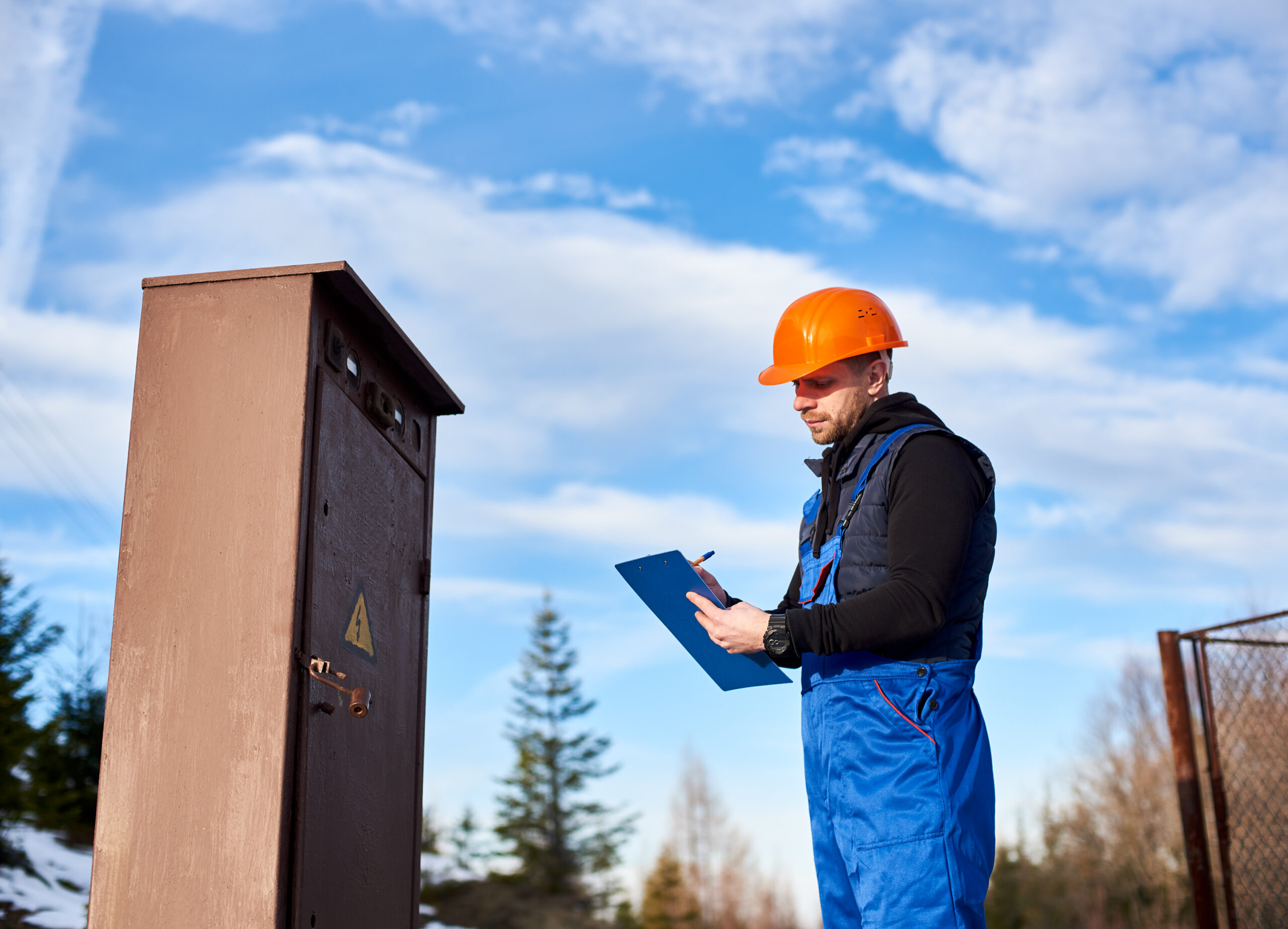 Technician recording essential services test results during a scheduled inspection