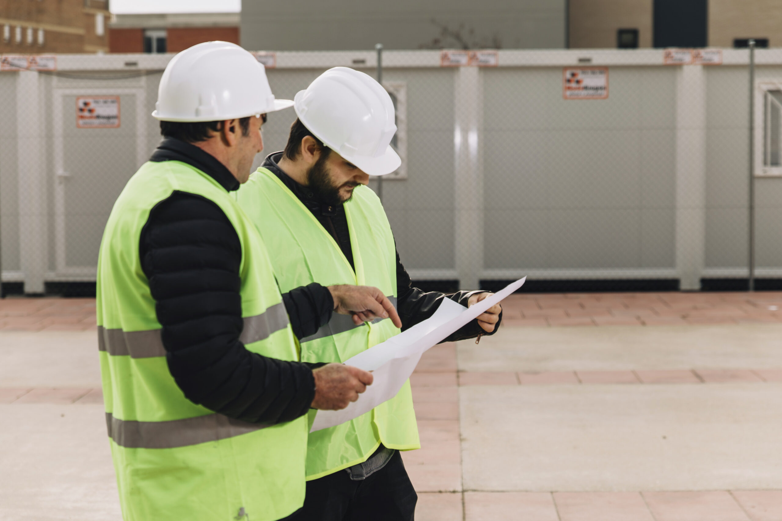 Building manager and inspector reviewing a building condition report