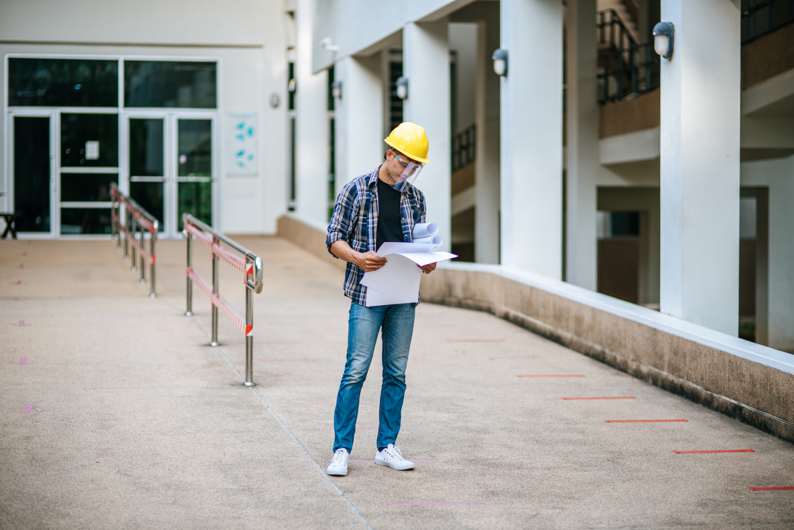 Facilities manager reviewing building asset documentation on site